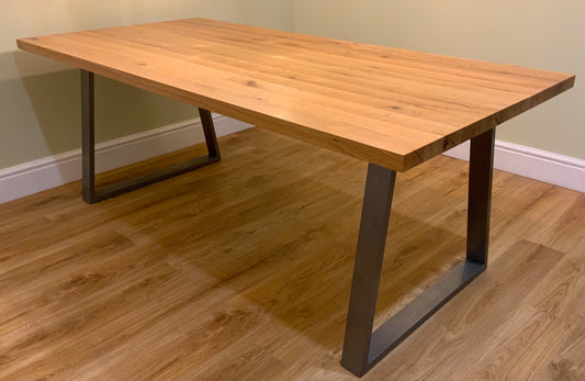 Solid oak dining table with industrial metal legs