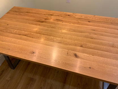 Solid oak dining table with industrial metal legs